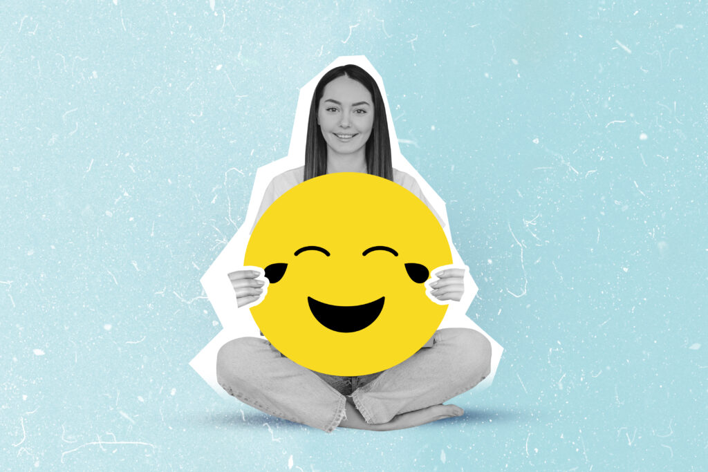 happy girl holding large smiley emoji collage isolated on blue color background